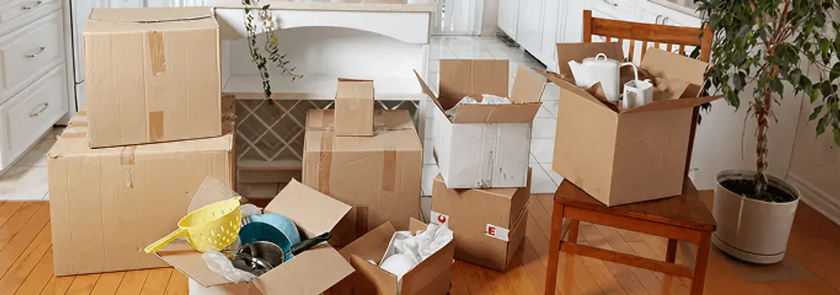 Packed moving boxes and household items in a kitchen before move-out or move-in cleaning, Saint Petersburg, FL.